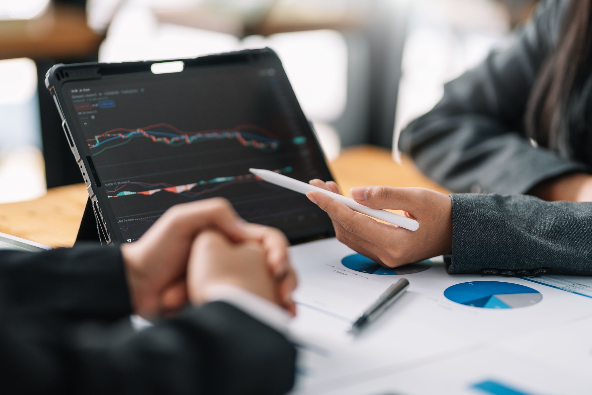 Businesspeople analyzing internal stock market investment.